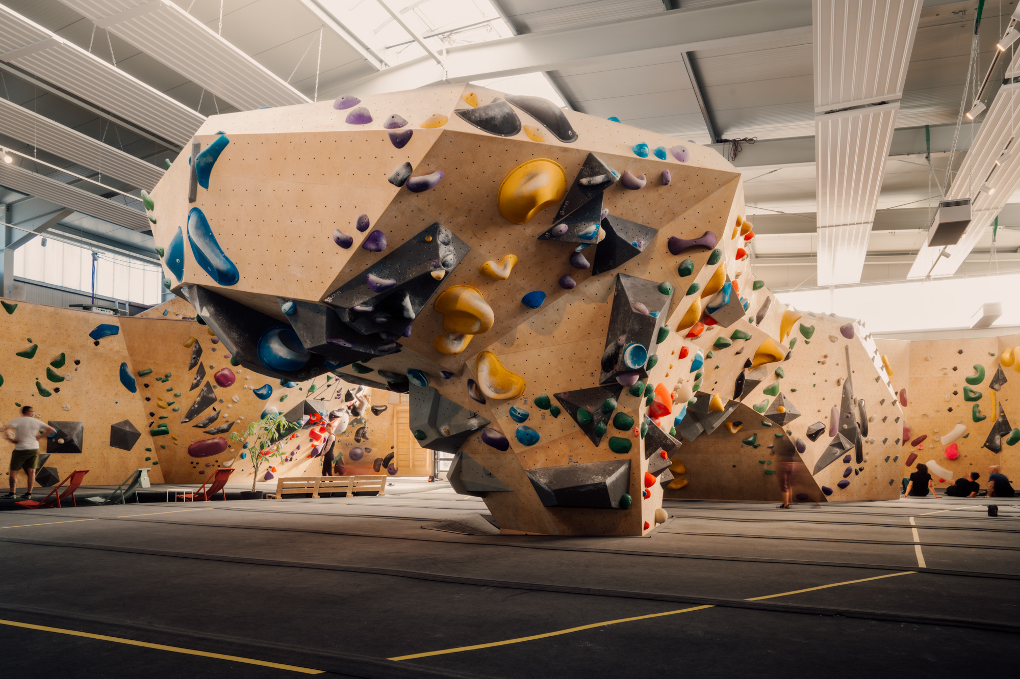 climber swinging on hold in climbing gym